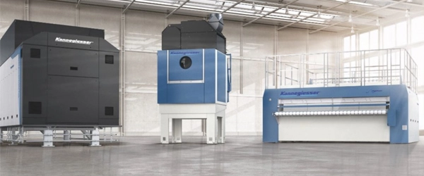 Industrial laundry equipment line in a modern facility.